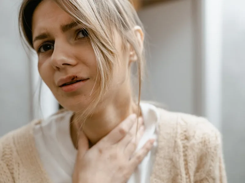 Pharmacist assessing sore throat
